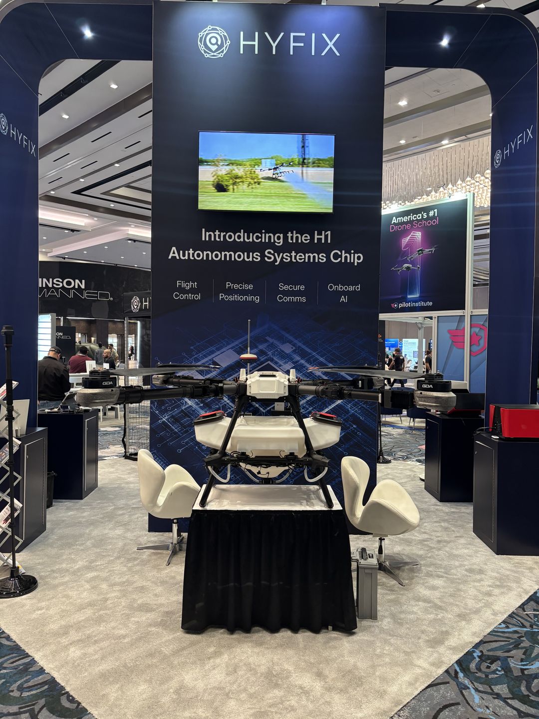 Multirotor aircraft displayed beneath an exhibit about an autonomous systems chip.